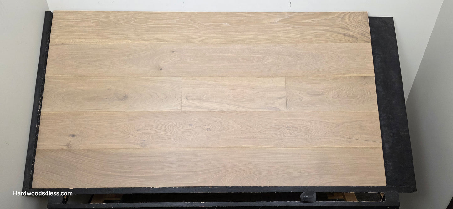 9 1/2" x 9/16" Engineered White Oak Daphne Hardwood Flooring shown head on. On a black shooting rack. 