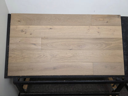 9 1/2" x 9/16" Engineered White Oak Elysian Hardwood Flooring. Shown on a black shooting table. Center shot.