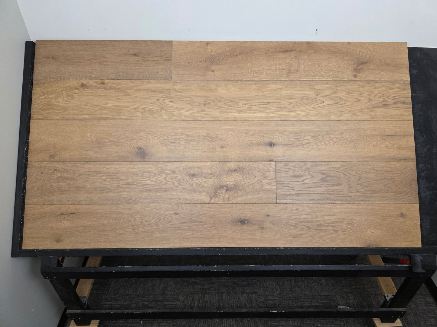 9 1/2" x 9/16" Engineered White Oak Oikos Hardwood Flooring. Shown on a black shooting table. Center shot.