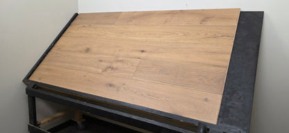 9 1/2" x 9/16" Engineered White Oak Oikos Hardwood Flooring. Shown on a black shooting table. Wide right hand shot. 