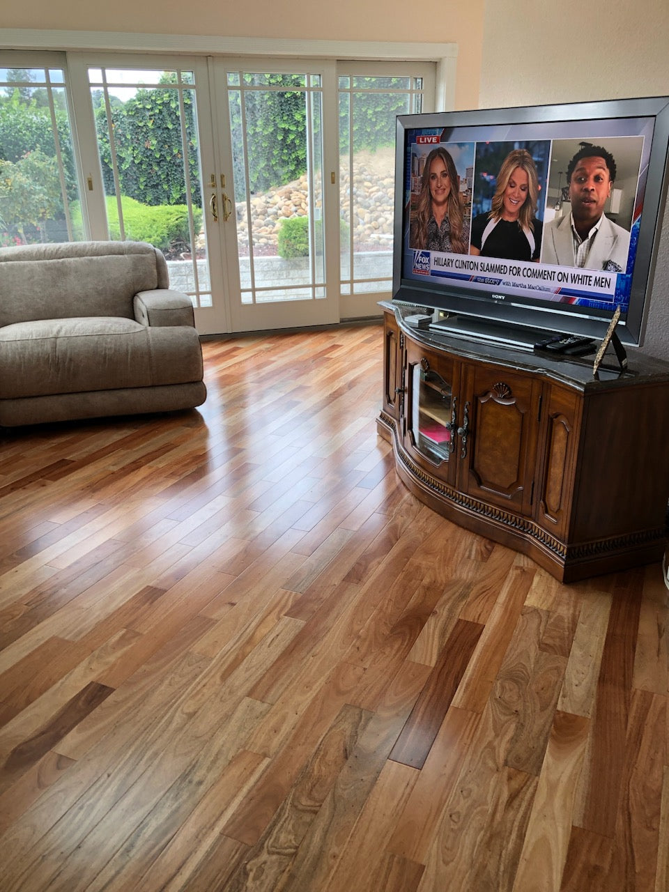 African Amendoim Hardwood Flooring installed in a living room with fox news on the tv. gross.