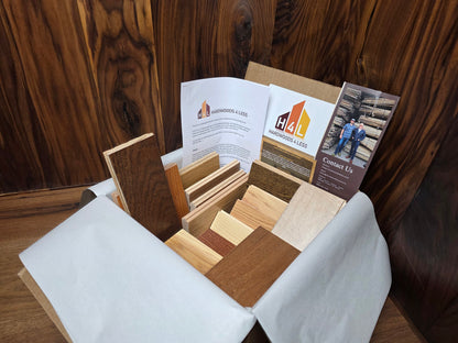Hardwood Flooring sample box with wood swatches and brochures on a wooden surface