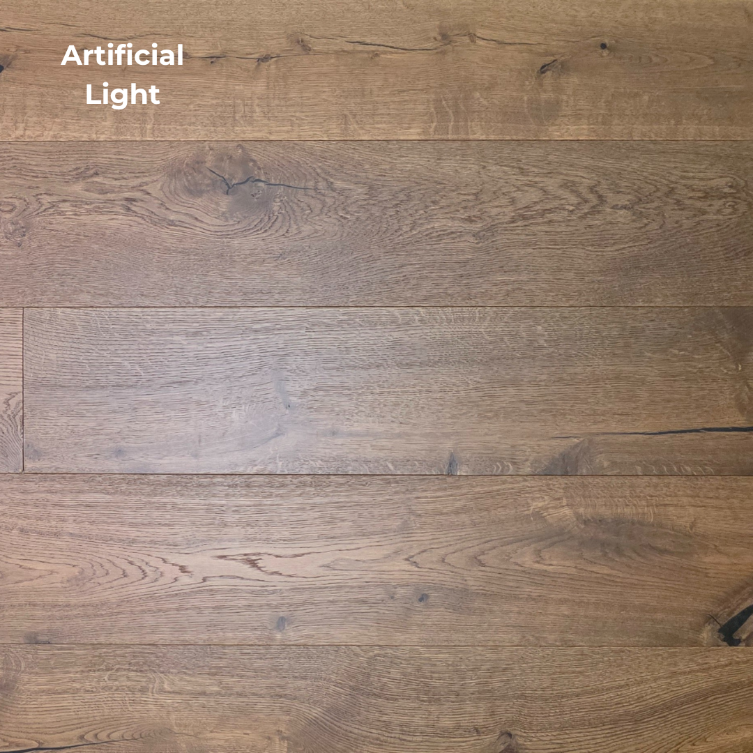 Wooden flooring with a visible grain pattern under artificial light