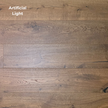 Wooden flooring with a visible grain pattern under artificial light