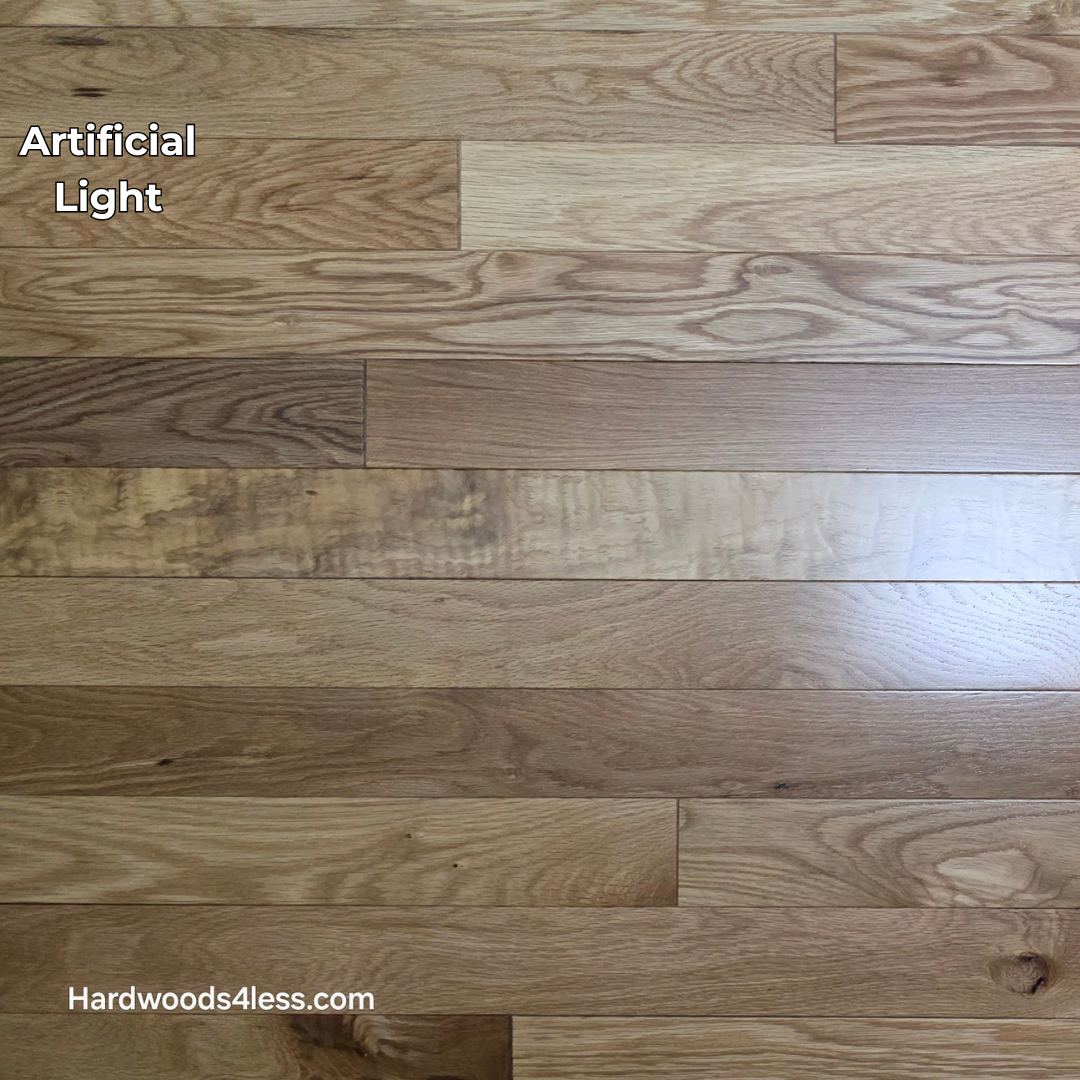 3 1/4" x 3/4" White Oak Natural Hardwood Flooring. Shown on a black shooting table. Shown in artificial lighting. 