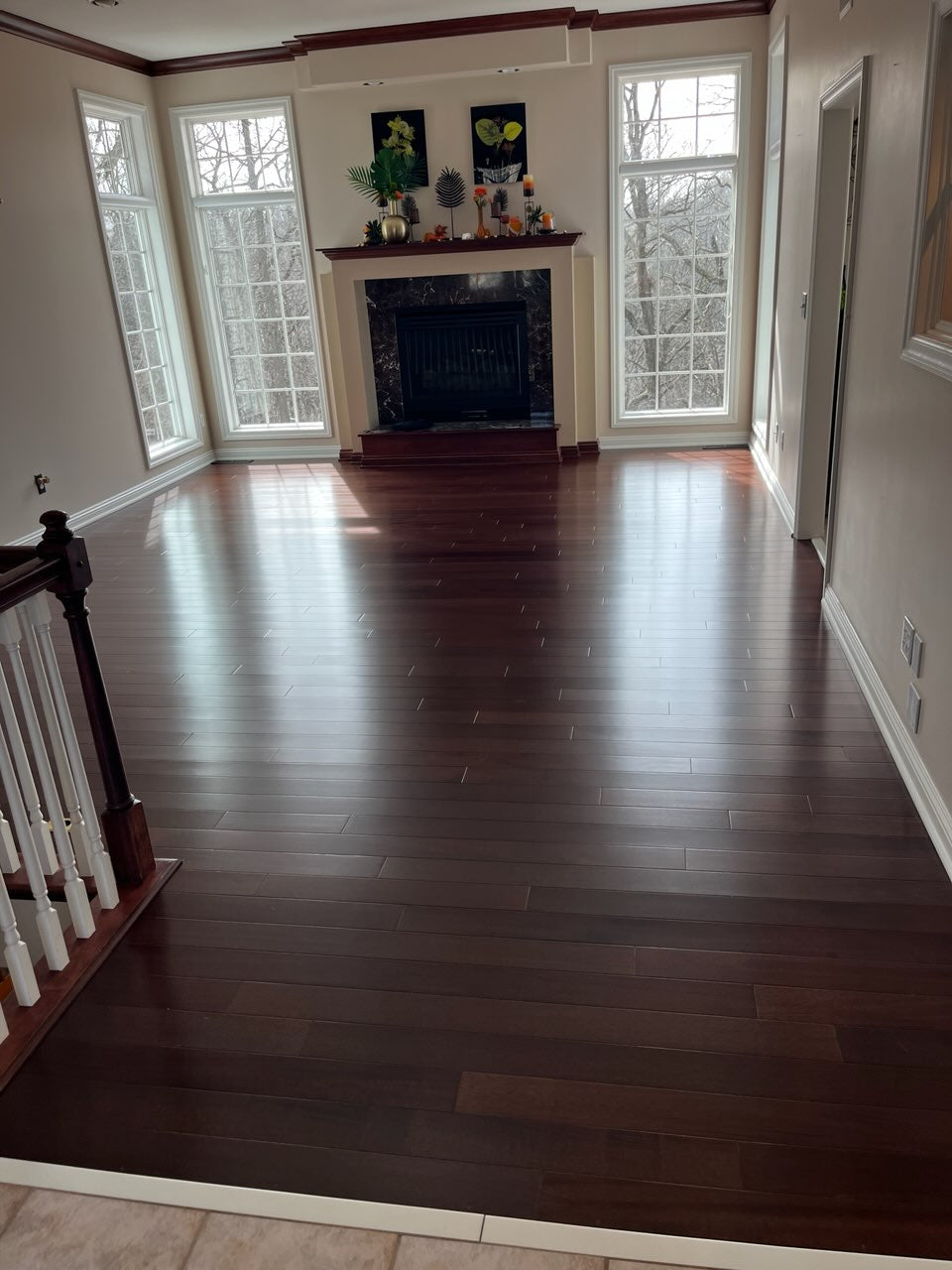 4" x 3/4" Solid Brazilian Oak Castanho Hardwood Flooring. Installed in a living room. This time it is empty, just the floor and fireplace. 