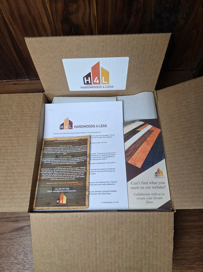 Open cardboard box with printed materials and a hardwoods4less logo on a wooden surface