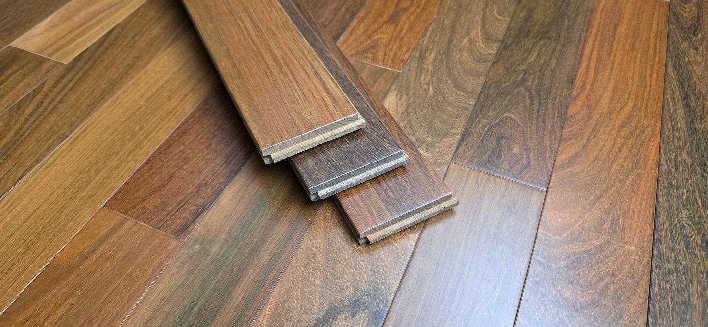 3 1/4" x 3/4" Prefinished Solid Brazilian Walnut (IPE) Natural Hardwood Flooring. Shown as three planks stacked upon the flooring.
