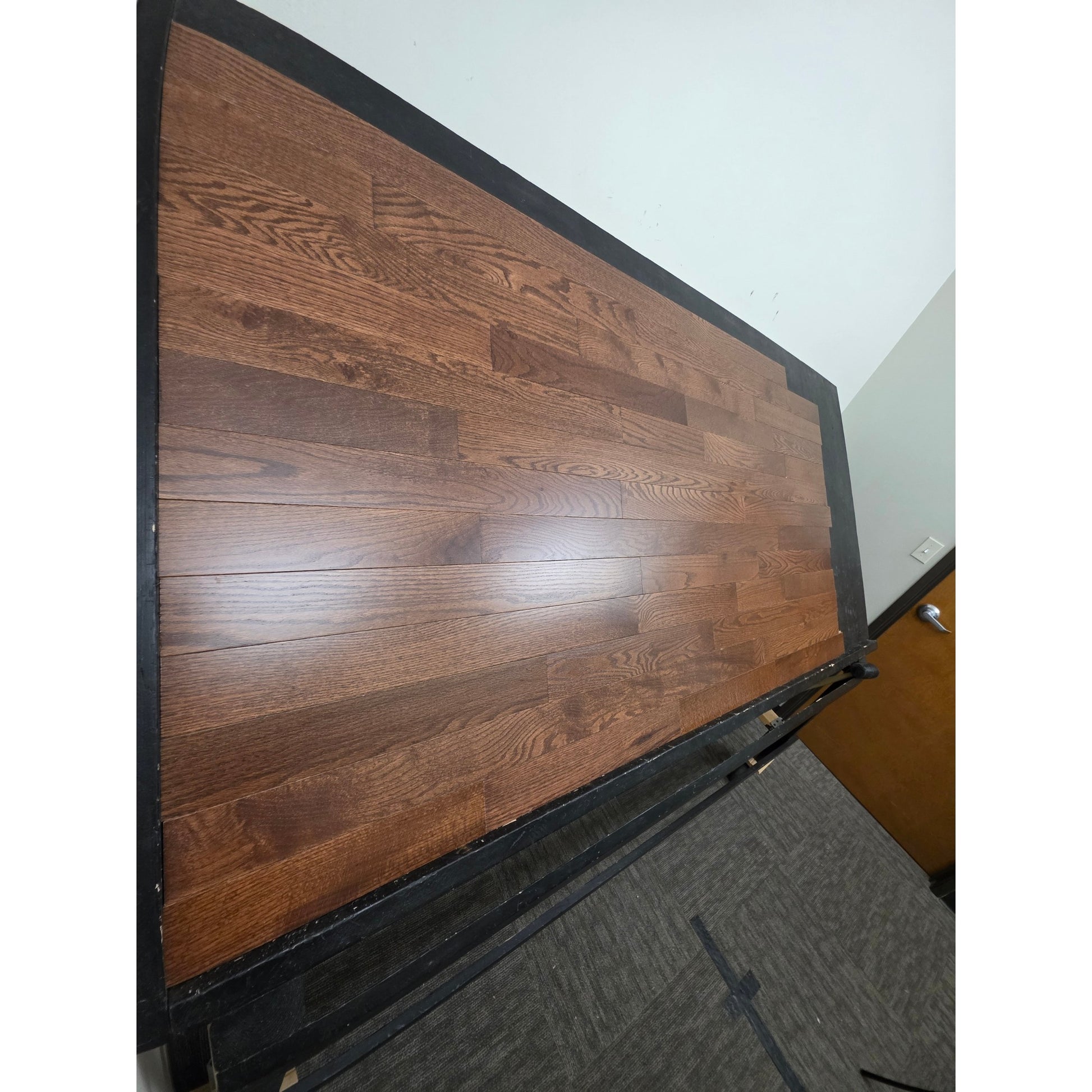 3 1/4" x 3/4" Oak Auburn Hardwood Flooring. Shown on a black shooting table. Shot from steep left. 