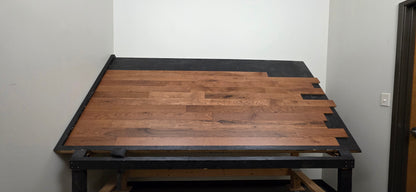 Table shot of Red Oak Gunstock Character Grade Hardwood Flooring on a black table 