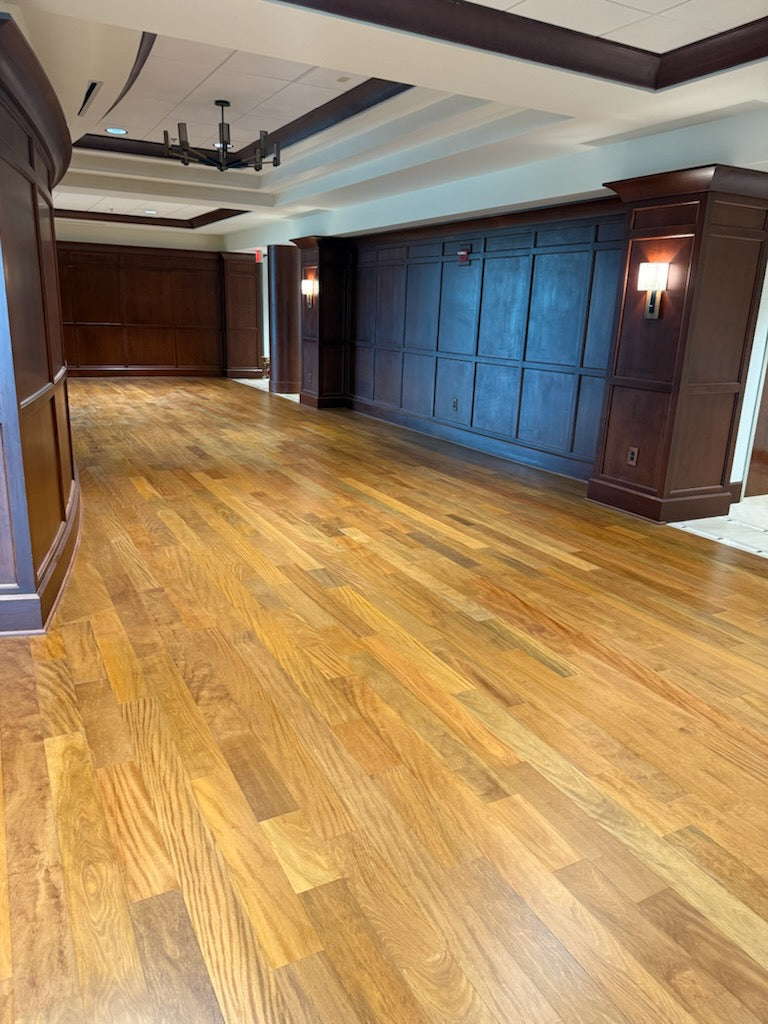 Brazilian Teak Hardwood Flooring shown installed in a hallway with dark brown accents
