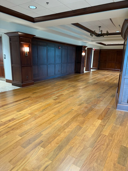 Brazilian Teak Hardwood Flooring shown installed in a hallway with dark brown accents and a white ceiling