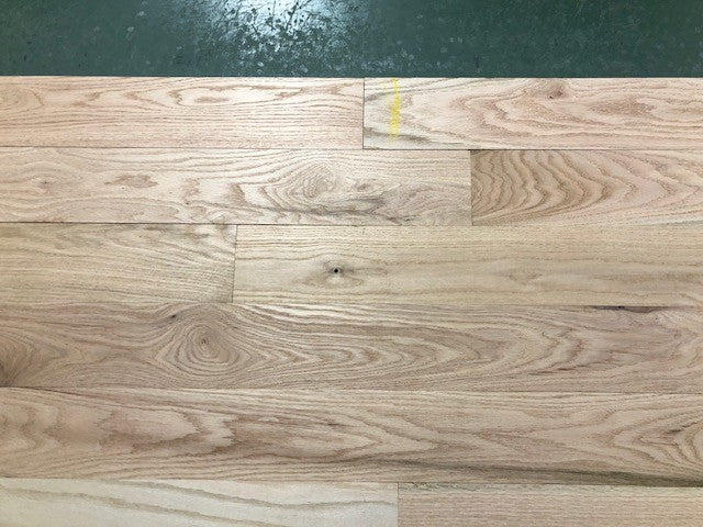 Unfinished Red Oak #1 Common Solid Hardwood Flooring. close up green background