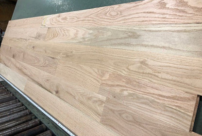 Unfinished Red Oak #1 Common Solid Hardwood Flooring. Wide right angle shot on a green racking table.