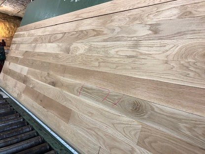 Unfinished White Oak #1 Common Solid Hardwood Flooring. Closeup on a green shooting table. 