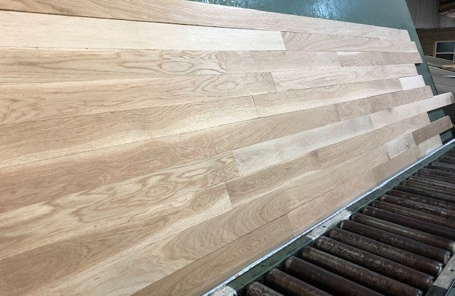 Unfinished White Oak Select & Better Solid Hardwood Flooring shown on a green shooting rack long left hand shot.