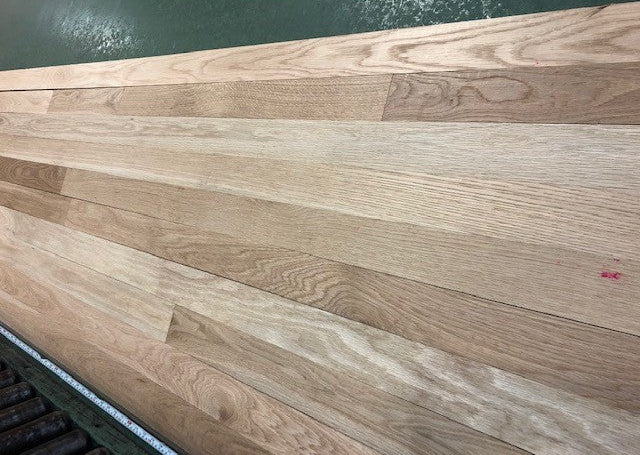 Unfinished White Oak Select & Better Solid Hardwood Flooring shown on a green shooting table close up right angle image
