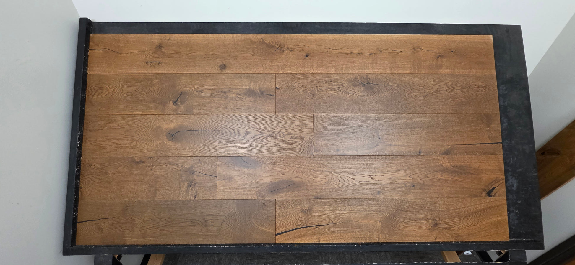 Engineered European Oak Beamline Hardwood Flooring on a black table 