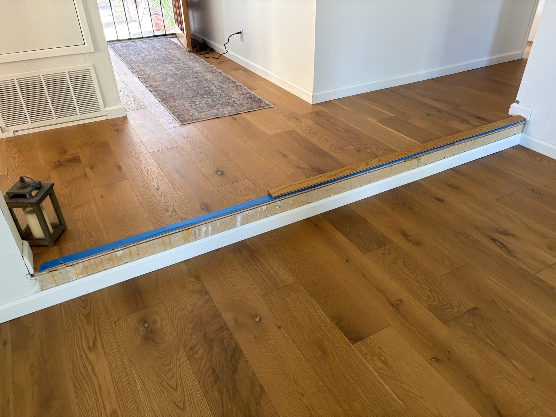 7 1/2" x 9/16" Engineered European Oak Rathlin Hardwood Flooring. Installed in a transitionary room.