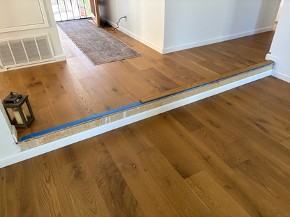 7 1/2" x 9/16" Engineered European Oak Rathlin Hardwood Flooring. Installed in a transitionary room.